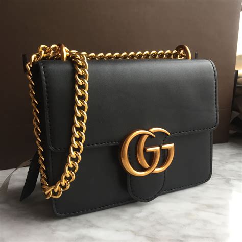 black and gold gucci purse|Gucci purse with gold chain.